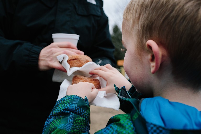 Boy chooses donut on the bottom of the pile 