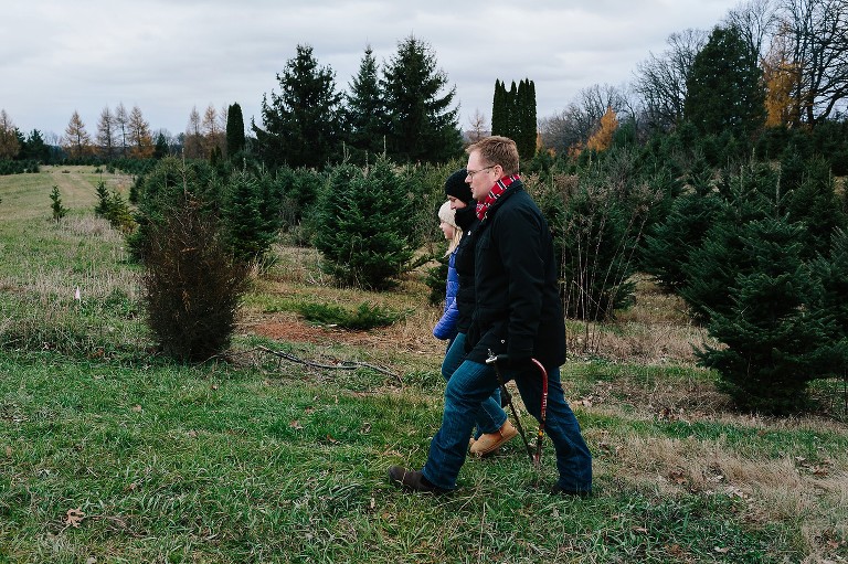 Profile of family inspect a Christmas tree at a tree farm