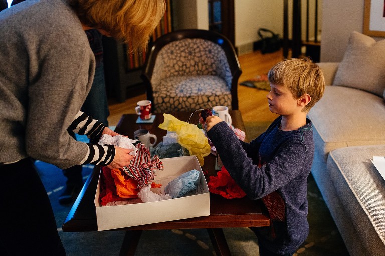 Mom and son unpack Christmas decorations in a box