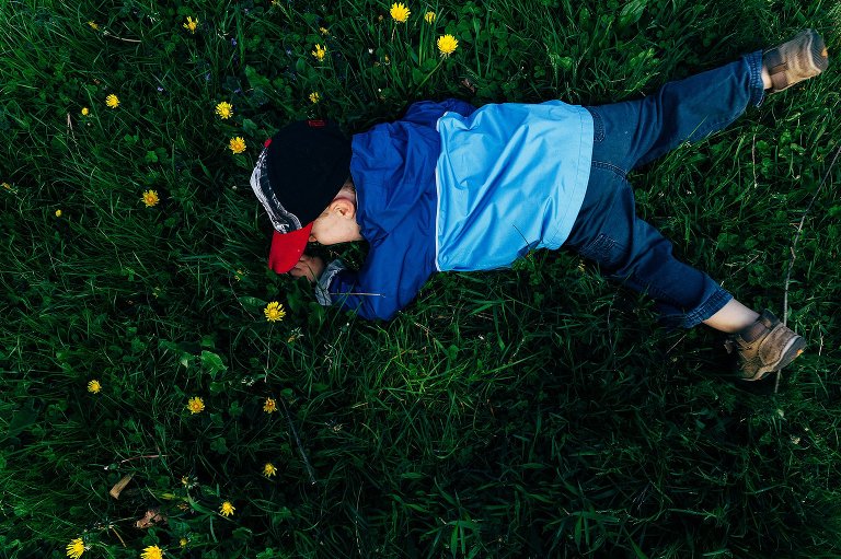 Preschooler plays in a field of dandelions 