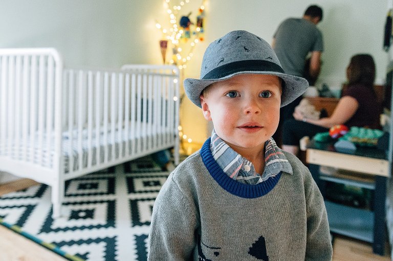 Toddler boy wears dapper hat and sweater