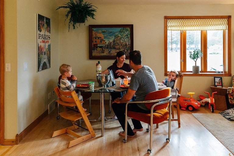 Family sits at table for breakfast
