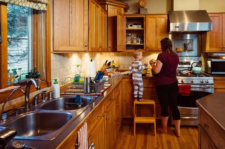 Preschooler and mom make waffles for breakfast 