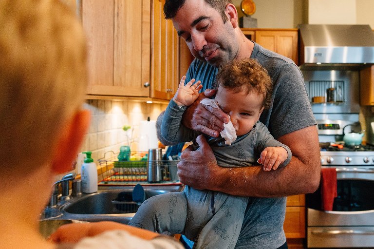 Dad washes toddler's face