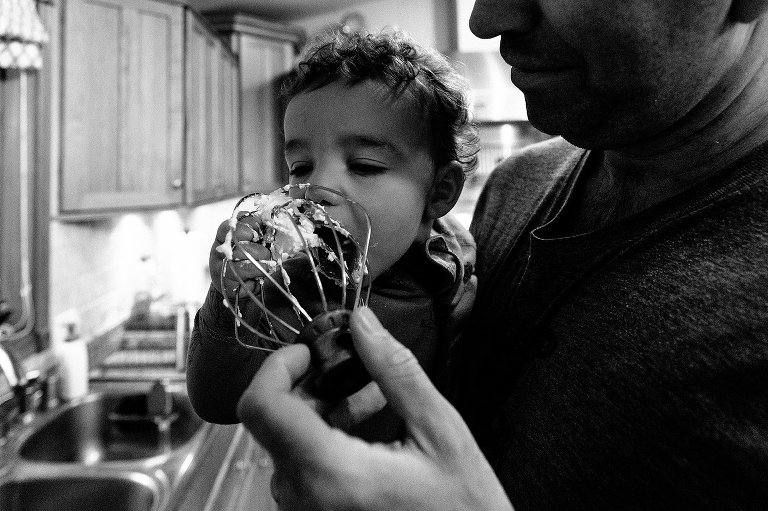 Toddler eats whipped cream from beaters 