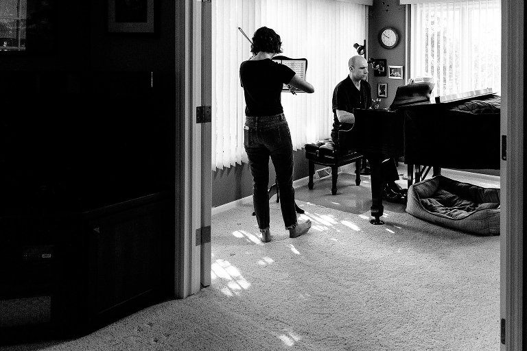 Dad and teen daughter play violin and piano duet 