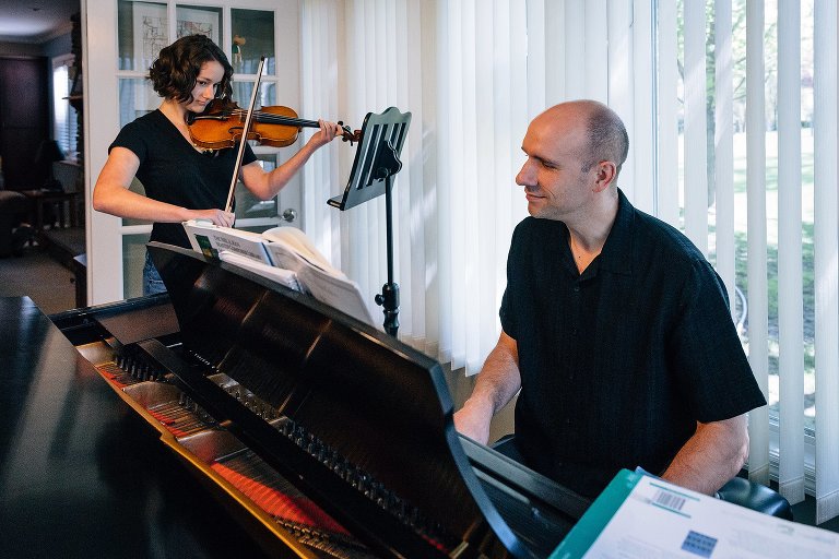 Dad and teen daughter play violin and piano duet 