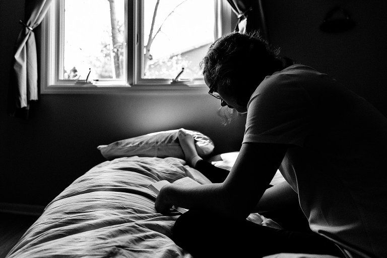 Teen girl reads in her bedroom 