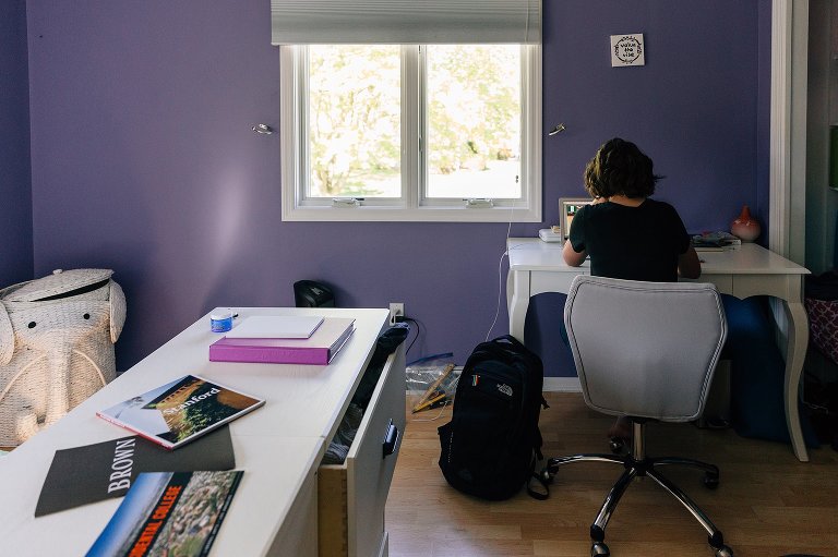 High school girl studies in her room