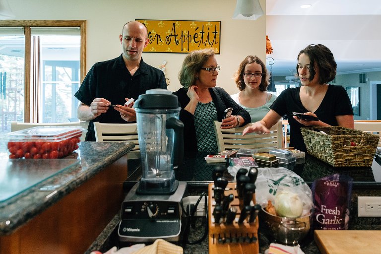 Four family members choose their own deck of cards from a basket. 
