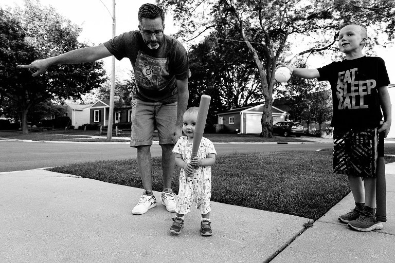 Dad and brother show toddler girl which way to first base