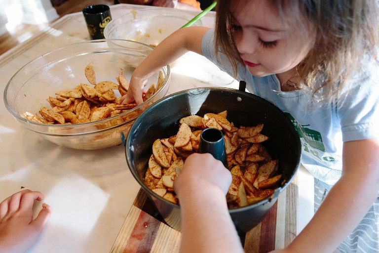 Child helps fill the bundt cake pan 