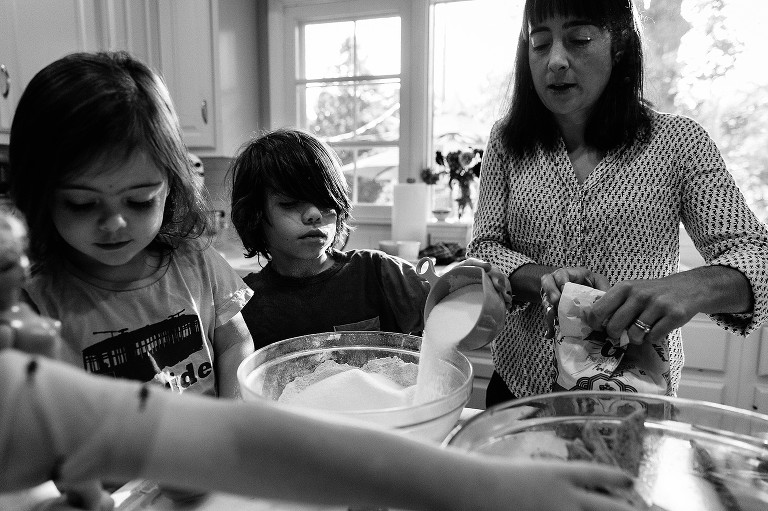 Boy adds sugar to bowl. 