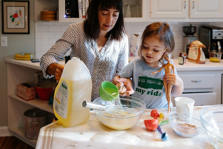 Youngest daughter adds oil and holds Barbie