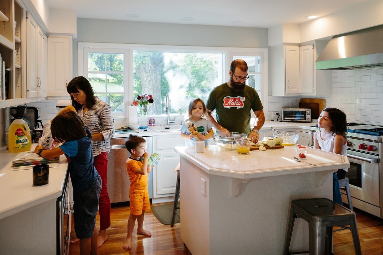 Whole family gathers in the kitchen to bake together 