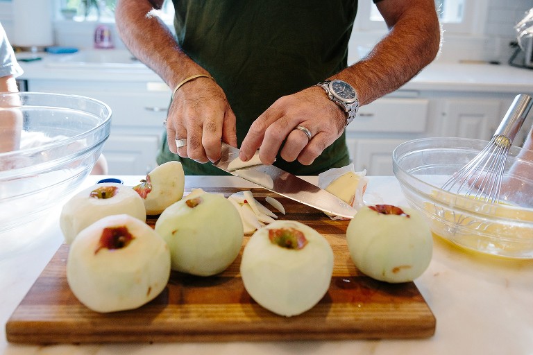 Dad slices apples in kitchen 