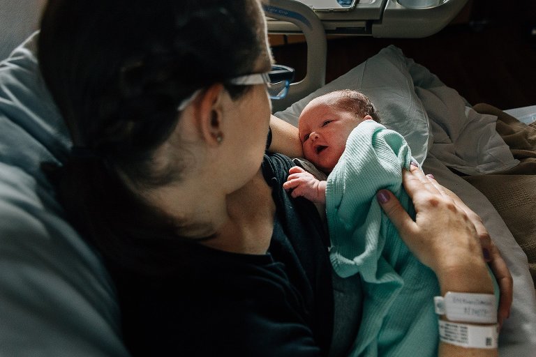 Newborn looks at mother