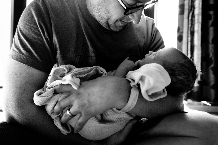 Dad holds newborn 