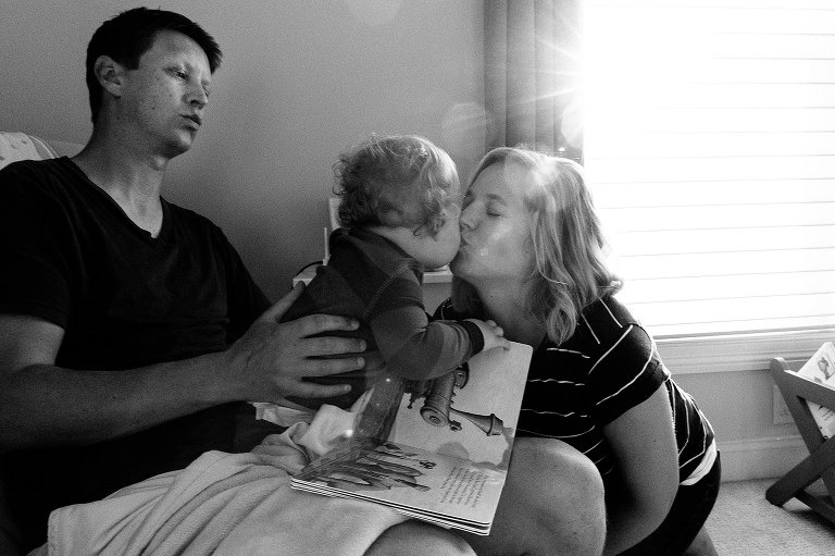 mom and toddler son kiss goodnight 