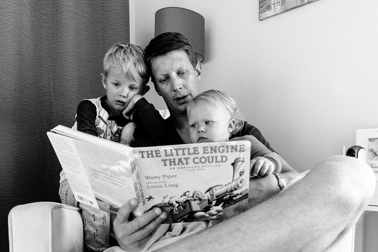 Dad reads book to sons 