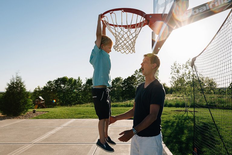 Dad excited son can hang on basketball hoop
