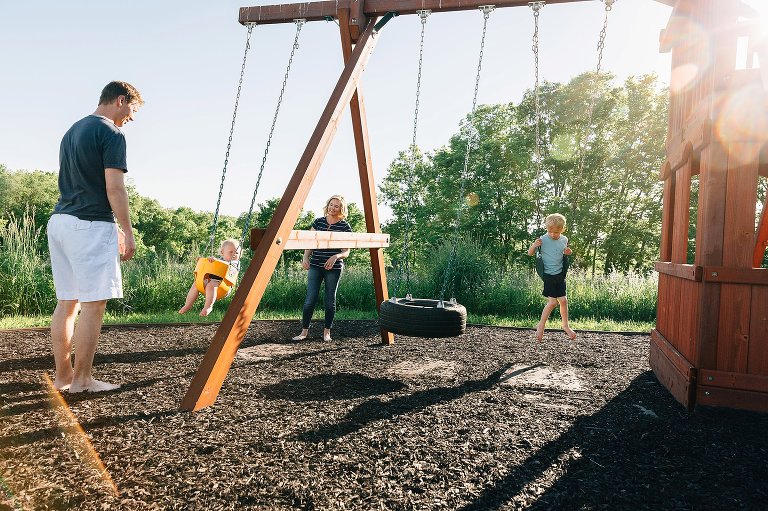 family plays on swings