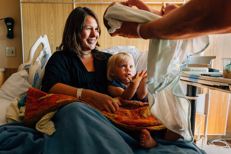 Big sister anticipates holding newborn sibling