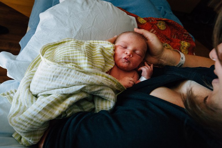 Sleeping newborn in colorful blankets 