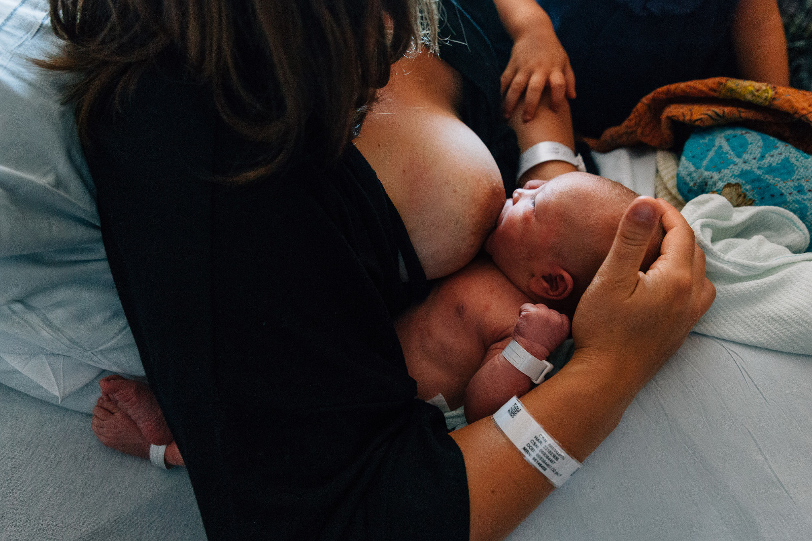mother nurses newborn at hospital