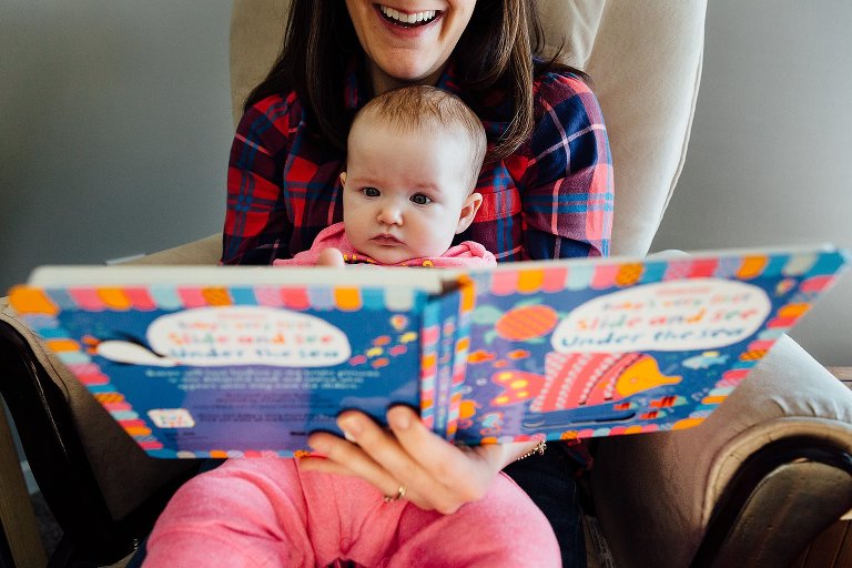 Mother reads to baby daughter