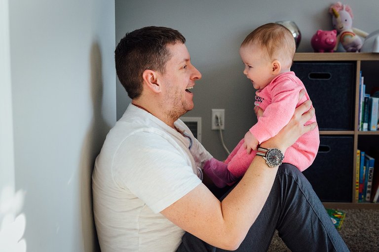 Dad and baby smile at each other. 