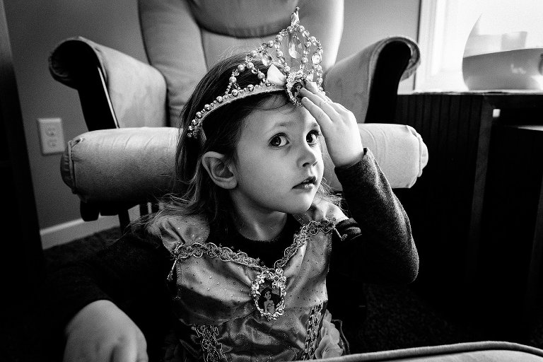 girl pushes toy crown back onto her head