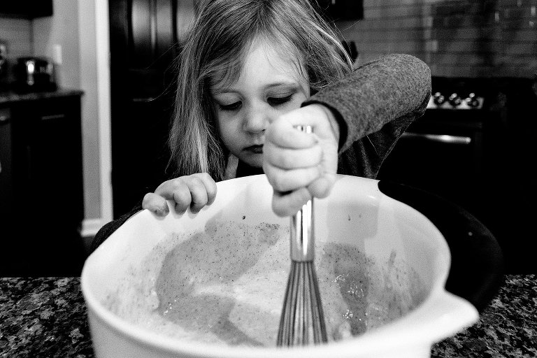 Girl hand mixes pancake batter. 