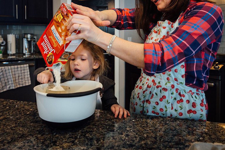 Young girl and mother make pancakes 