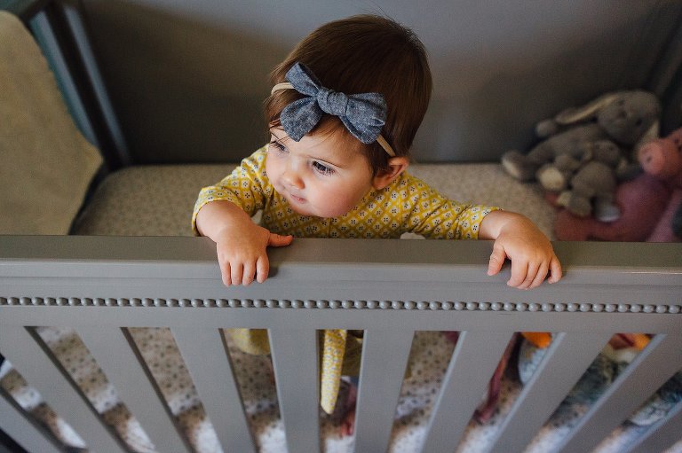 Top down view of baby standing in crib.