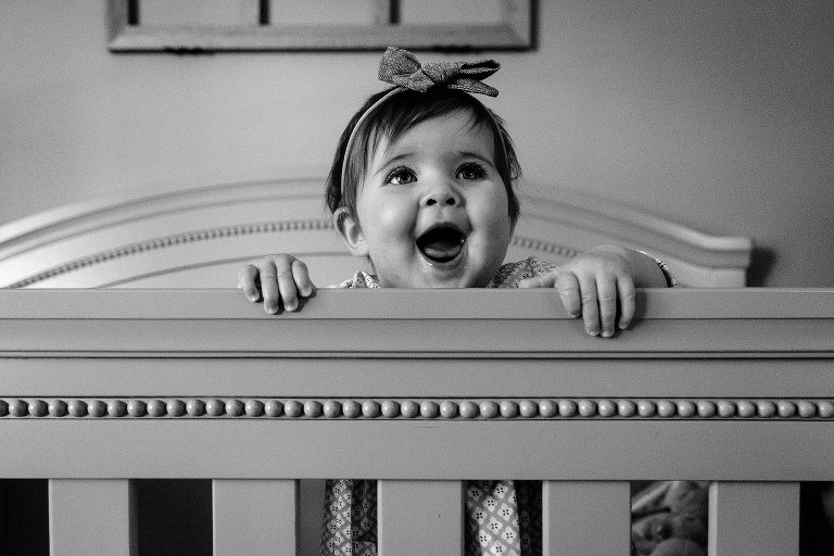 Smiling baby in crib.