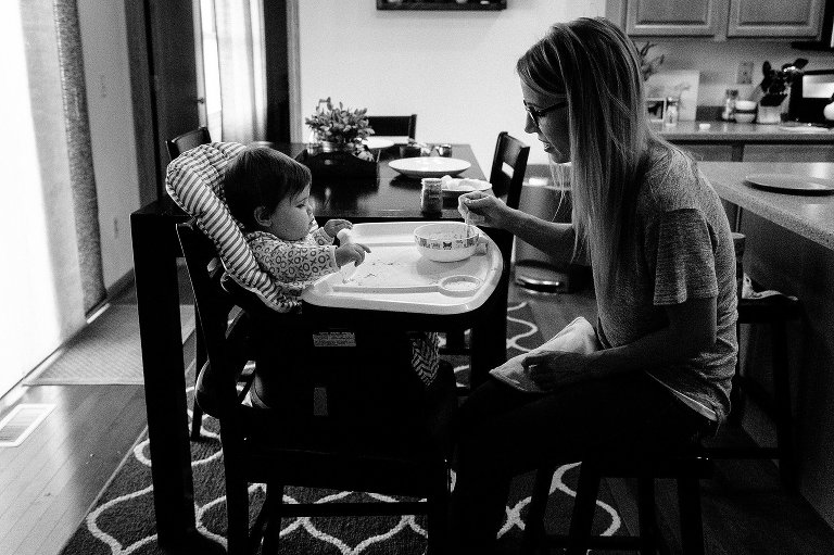 Mom and daughter sit across from each other during breakfast
