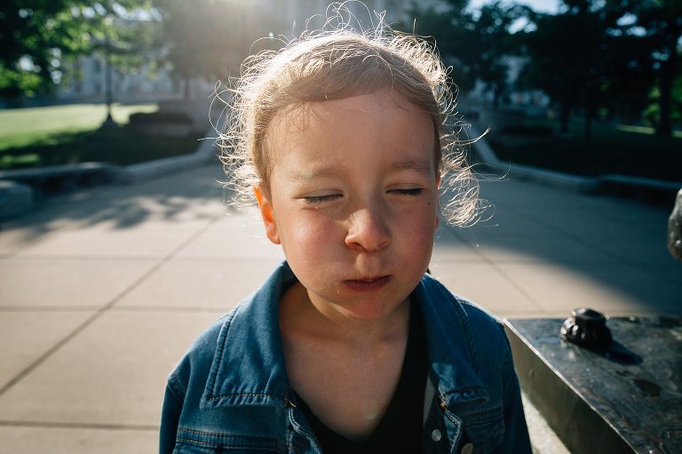 Girl has a cheek full of cherry tomatoes 