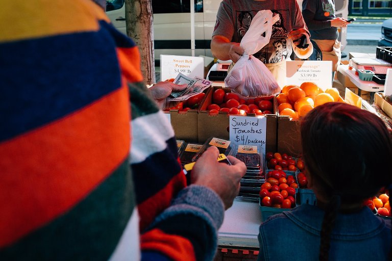 Wisconsin Farmer's Market man pays for tomatoes