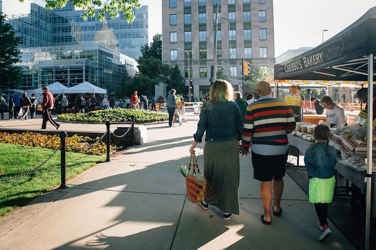 Family walks through Dane County Farmer's Market in Madison, WI 
