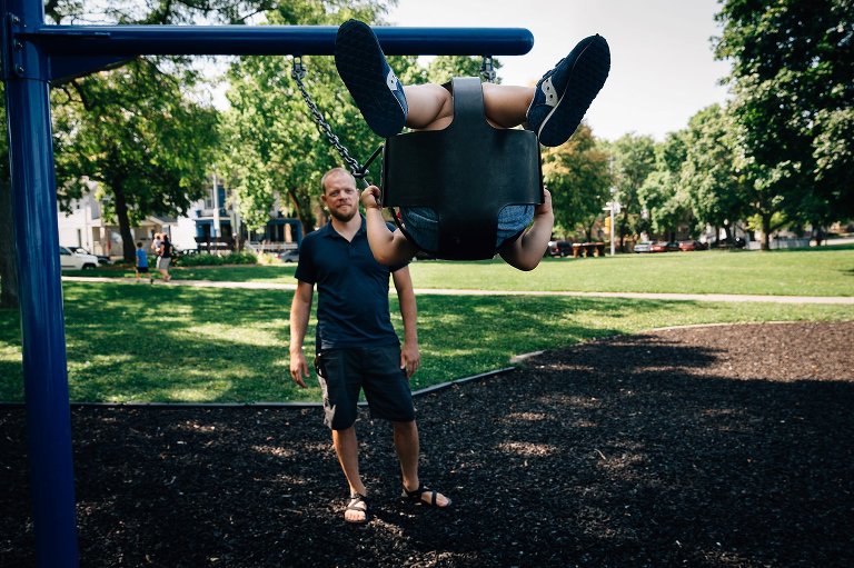 Daughter swings high and only feet and legs. are visible. 