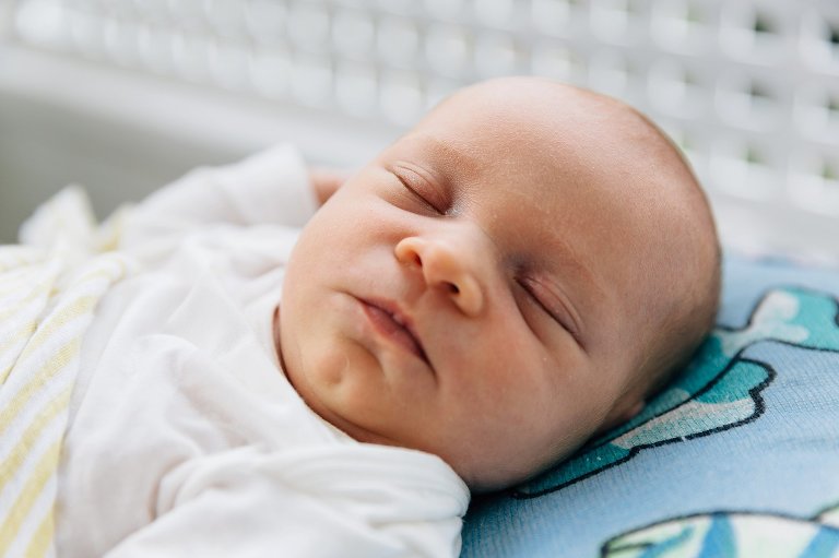 Newborn baby sleeps on porch on warm summer day. 