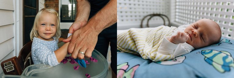 Dad wipes toddler hands of play-dough while newborn sleeps on nearby Boppy.