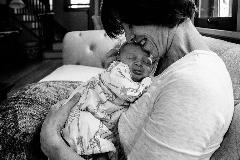 a mothers hold her newborn baby against her chest