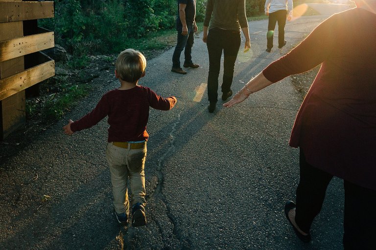 Grandma reaches for preschool boy's hand in a tunnel 