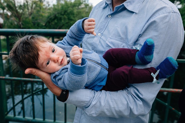 Baby girl resting in dad's arms. 