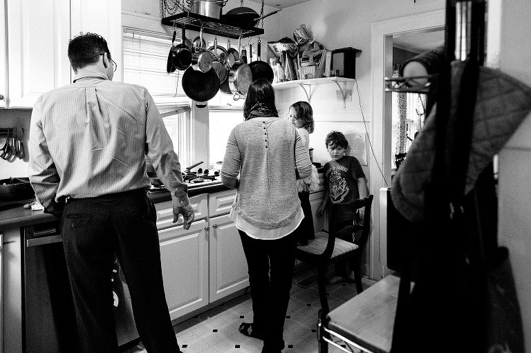 Black and white. Family in the kitchen getting ready for breakfast. 