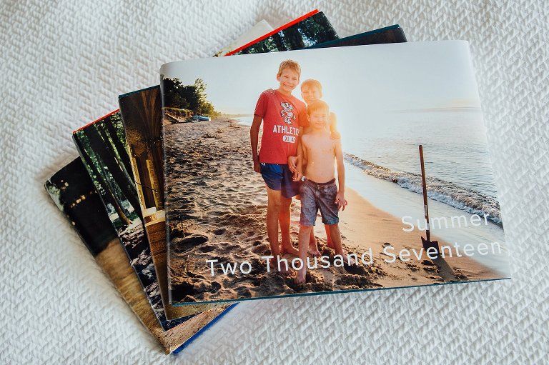 a stack of 4 personalized family albums about summer 