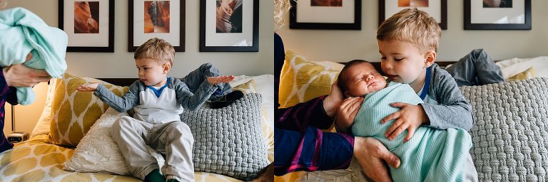 Young boy eagerly awaits his mother placing newborn sister in his open arms. 