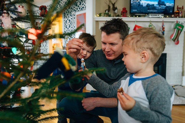 dad shares a favorite childhood Christmas ornament wiht young sons. 